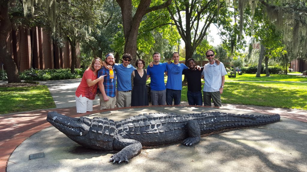 The GeoPlan team standing around a gator sculpture on the University of Florida campus.